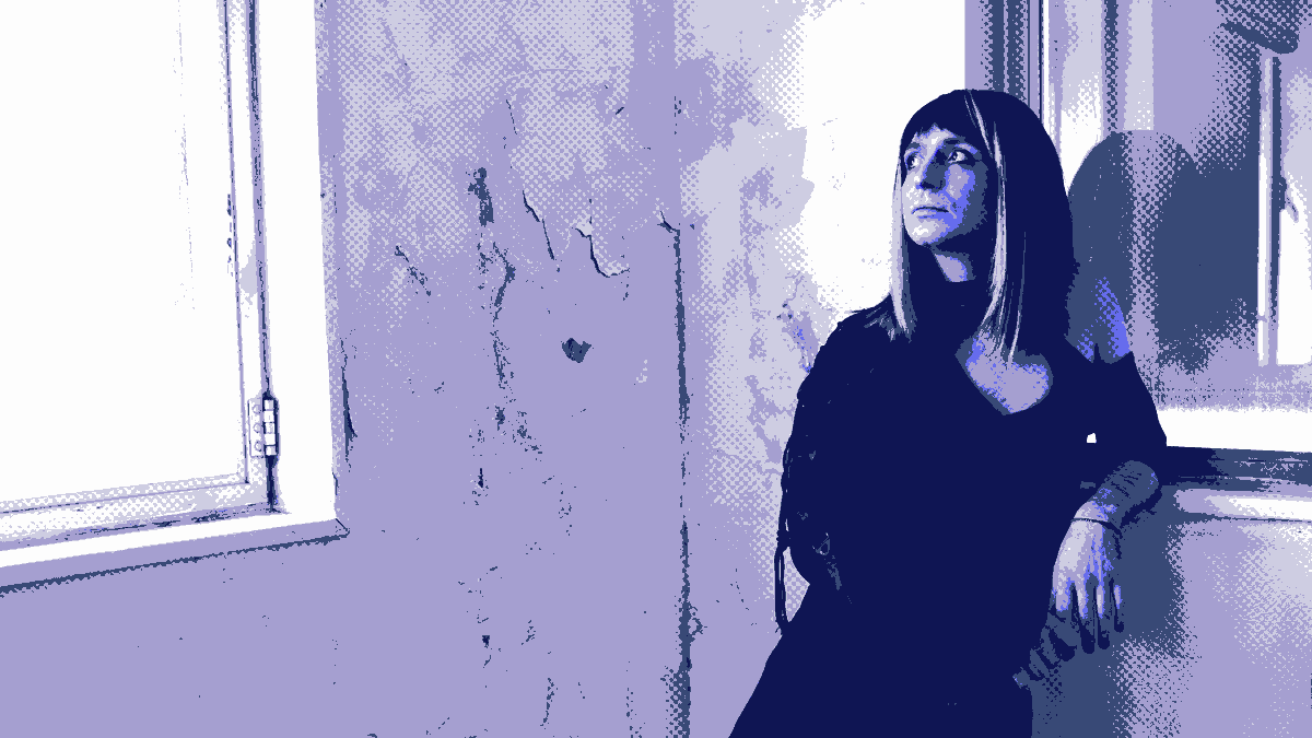 Dither compressed image of a white non-binary person dressed in black, in a shabby room with peeling walls